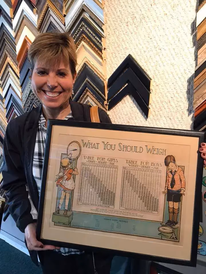 A happy Magnolia House customer with framed work