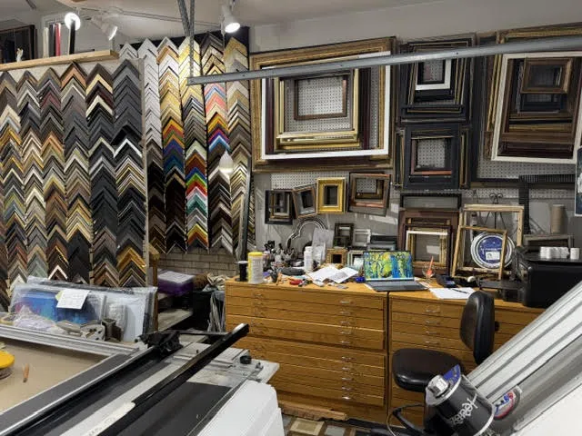 Ready-made frames and flat files behind the corner sample wall