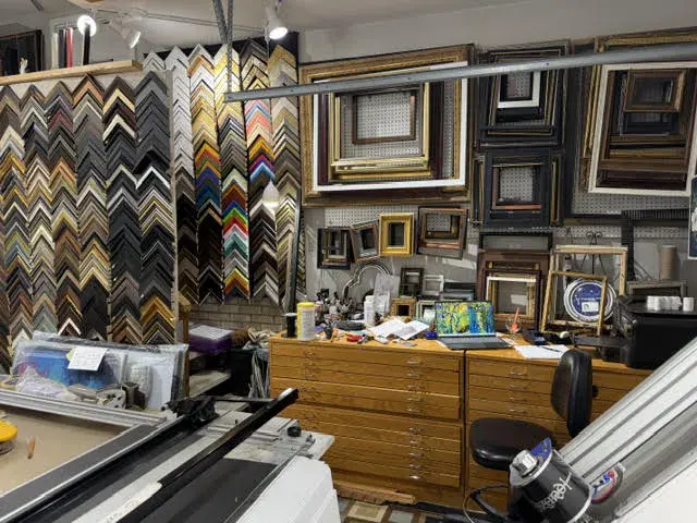Ready-made frames and flat files behind the corner sample wall